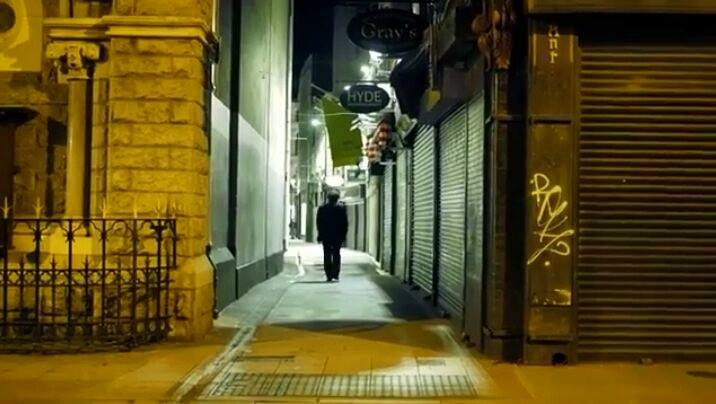 Lonely figure walking down Dublin Street